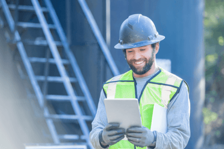 Oil and gas worker using a tablet on site